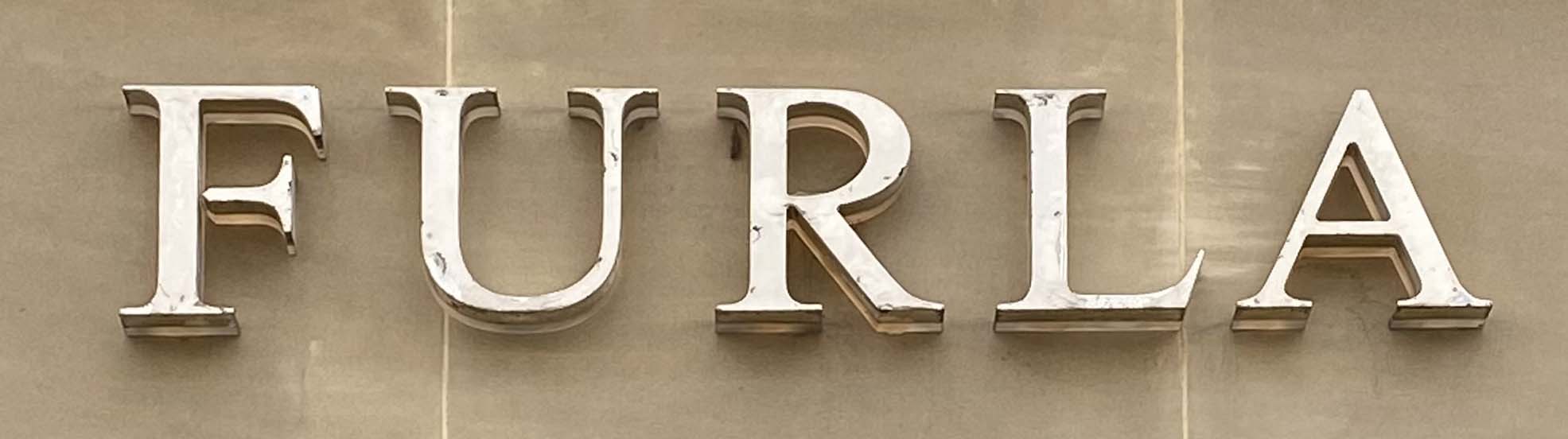 Sign at Furla store on Sloane Street in London