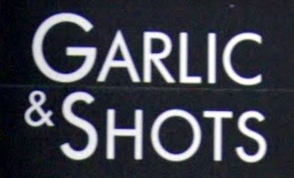 Sign at Garlic and Shots restaurant and bar on Frith Street in Soho