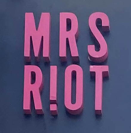 Sign at Mrs Riot bar on Henrietta Street in London